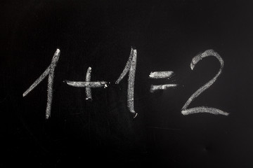 One add one on chalkboard , simple math addition