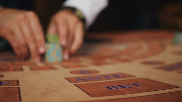 The dealer moves the player's winnings.
