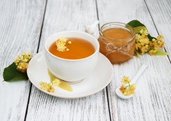 Obraz na płótnie Canvas cup of herbal tea with linden flowers
