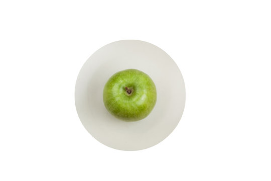 green apple on white plate isolated on white background