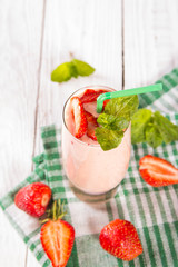 glass of smoothie, yogurt and fresh strawberries