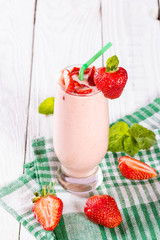 glass of smoothie, yogurt and fresh strawberries