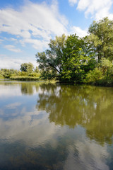 Fototapeta na wymiar Small lake with trees on the shore