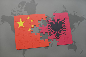 puzzle with the national flag of china and albania on a world map background.