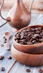 roasted coffee beans in wooden bowl, selective focus
