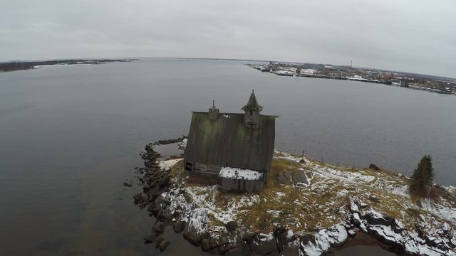 Aerial shot of abandoned wooden church by the White sea, on the mainland of Solovetsky islands