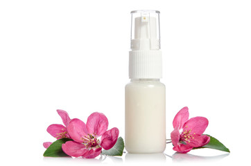 Fototapeta na wymiar Face cream bottle with pink flower isolated on white