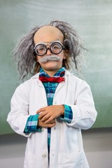 Boy dressed as scientist posing agains board - obrazy, fototapety, plakaty