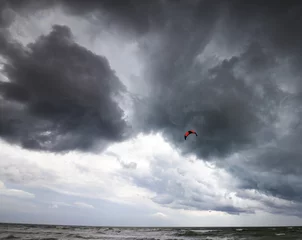 Tuinposter Power kite in sea and storm sky © BSANI