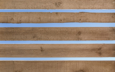 Wooden fence against the blue sky