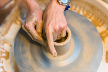 Fototapeta premium Pottering - creating a clay cup in process