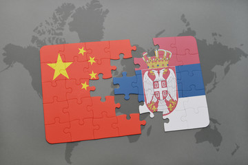 puzzle with the national flag of china and serbia on a world map background.