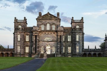 Fototapeta premium Seaton Delaval Hall, Northumberland, England, UK, bathed in evening sunlight. with dramatic clouds overhead.
