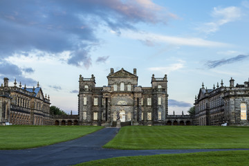 Seaton Delaval Hall, Northumberland, England, UK, bathed in evening sunlight. with dramatic clouds overhead.