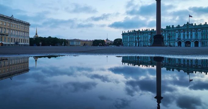 Russia, Saint-Petersburg, 03 July 2016: Time-lapse of Palace Square with night illumination, Winter Palace, Hermitage, Alexander Column, reflection in a water pool after a rain, a lot tourists, zoom