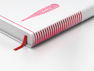 Health concept: closed book, Thermometer on white background