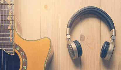 Fototapeta na wymiar Music Headphone and acoustic guitar for music banner.