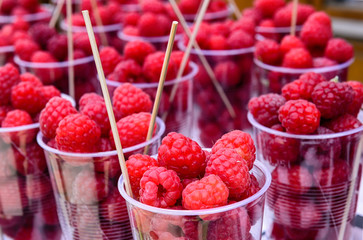 Raspberries sold in plastic cups on the street markets.