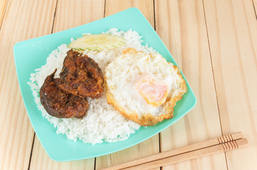 Fried spicy fish with rice and egg
