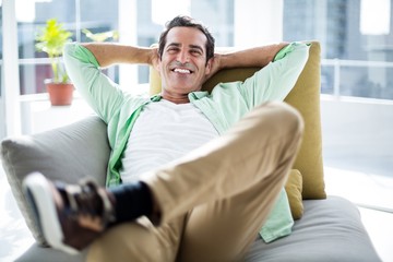 Happy man relaxing on sofa at home