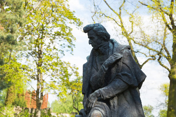 Fototapeta premium A statue in the park surrounding Fryderyk Chopin's Birthplace in Żelazowa Wola, Poland 