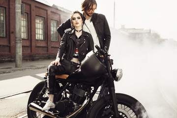 Obraz na płótnie Canvas Couple in love and vintage custom motorcycle