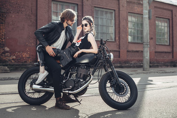 Fototapeta na wymiar Couple in love and vintage custom motorcycle