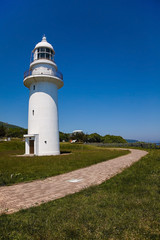 Fototapeta na wymiar Lighthouse standing in sunny park