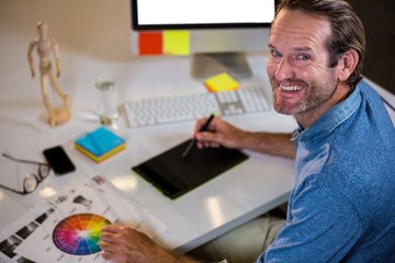 Portrait of businessman using graphics tablet