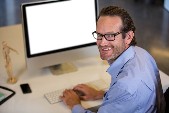 Creative businessman using computer at desk 