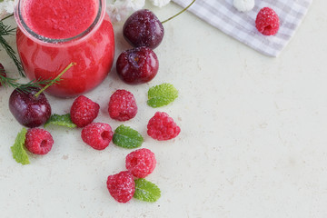 Delicious raspberry and sweet cherry smoothie or milk shake with
