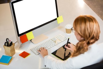 Creative businesswoman working at computer desk 