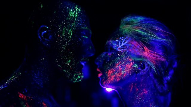 The tenderness of the couple ultraviolet light. Fluorescent powder.