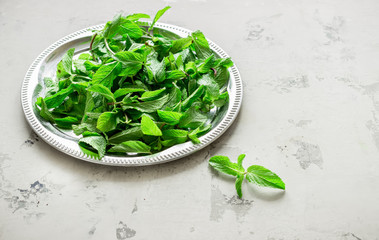 Silver tray with mint leaves.
