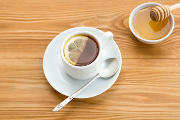 Herbal tea in a cup with  and honey dipper