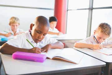 School kids doing homework in classroom