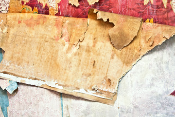 Old grunge tattered wallpaper in a destroy house