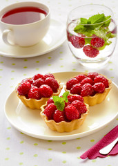 Fruit cakes: raspberries tarts on a table 