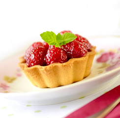 Fruit cakes: raspberries tarts on a table 