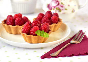 Fruit cakes: raspberries tarts on a table 