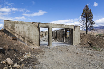 Burned house personal property loss after a fire. Ruined home caused by natural disaster wildfire.
