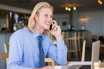 Happy man talking on mobile phone