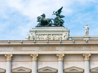 Fototapeta na wymiar Top of front facade of Austrian parliament building with bronze quadriga, Ringstrasse in downtown Vienna, Austria