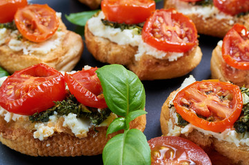 Bruschetta with roasted tomatoes, feta cheese and home made pest