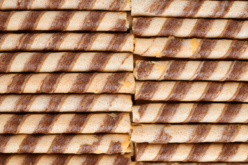 Striped wafer rolls filled with vanilla cream