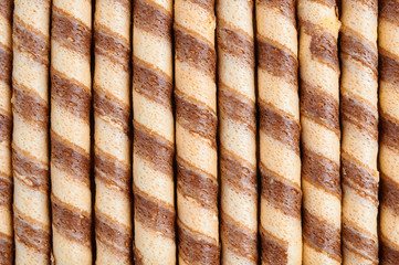 Striped wafer rolls filled with vanilla cream