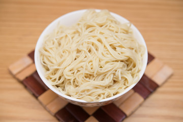bowl of noodles on a wood table
