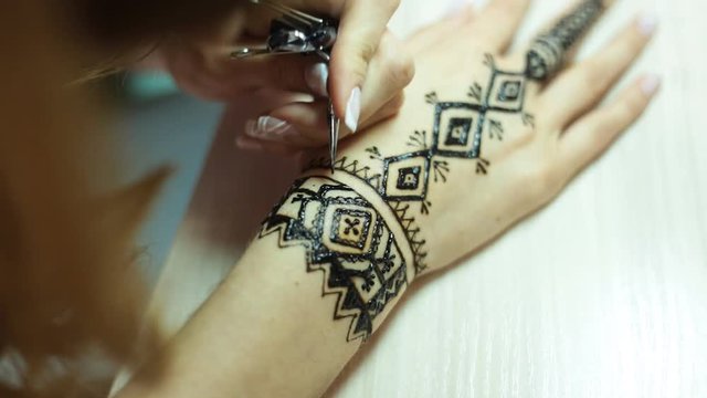 Henna tattoo on women hands
