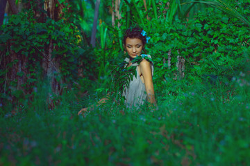 sensual portrait of young beautiful woman with jungle background