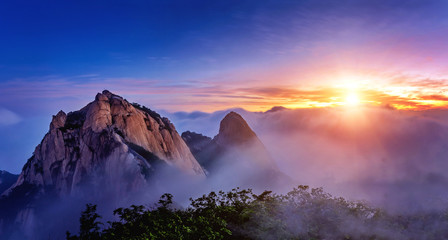 Bukhansan mountains is covered by morning fog and sunrise in Seo